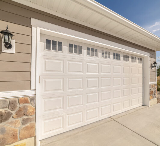 A beautiful, white garage door, one of many residential garage doors installed by American Eagle Garage Door Specialists.