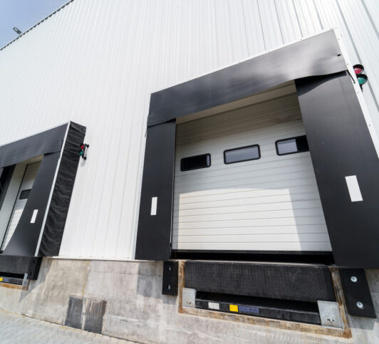 Several commercial garage doors and dock unloading equipment set up by American Eagle Garage Door Specialists
